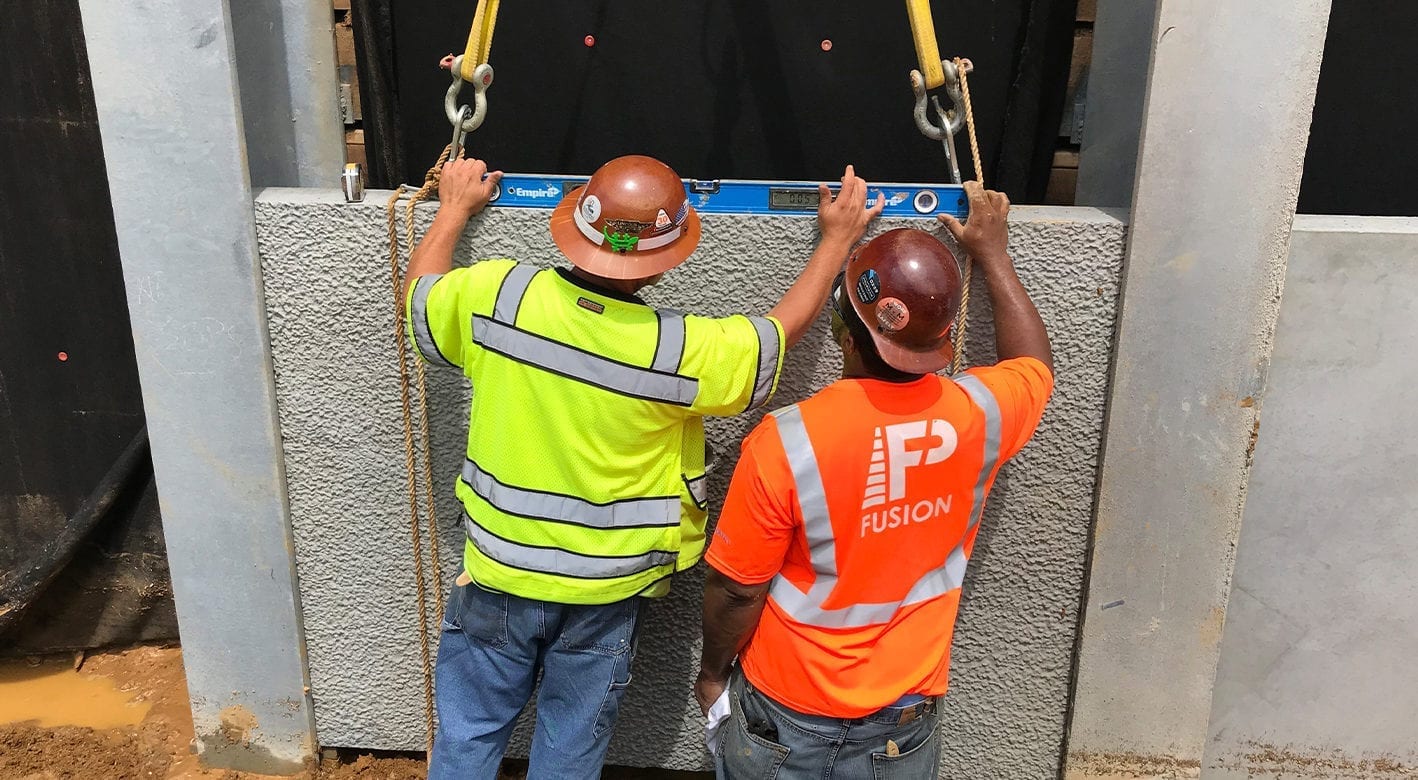 Smith Midland associates leveling a retaining wall