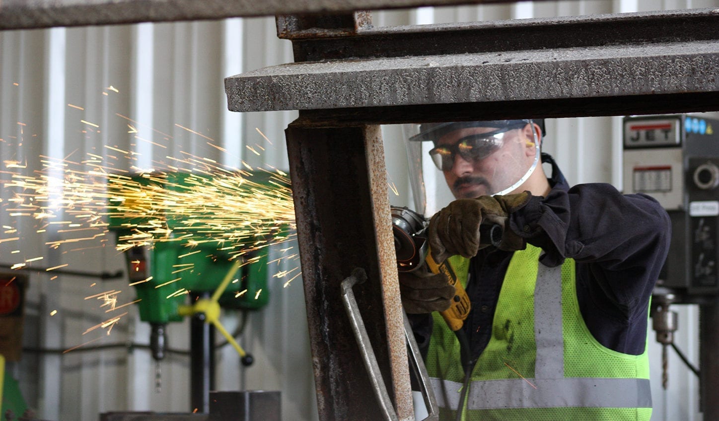 Smith Midland associate welding in the shop